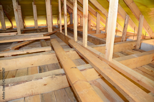 Roofing Construction Attic Insulation Interior. Wooden Roof Beams, Roof Truuses, Frame House Attic Construction.