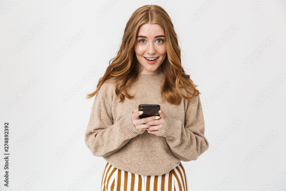 Attractive young girl wearing sweater standing isolated - obrazy, fototapety, plakaty 