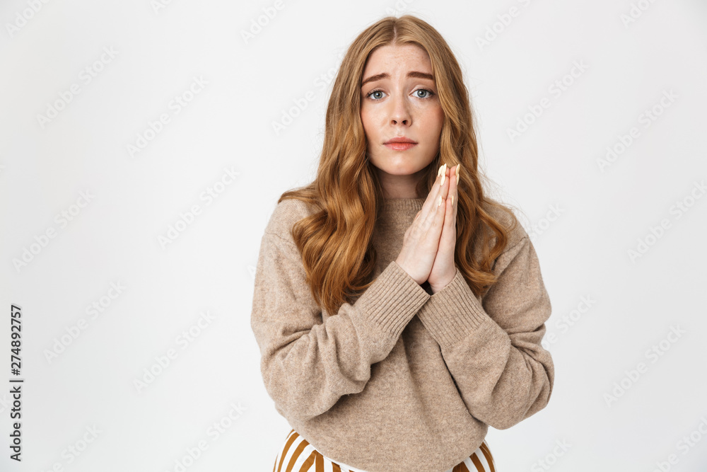 Attractive young girl wearing sweater standing isolated Attractive young girl wearing sweater standing isolated
