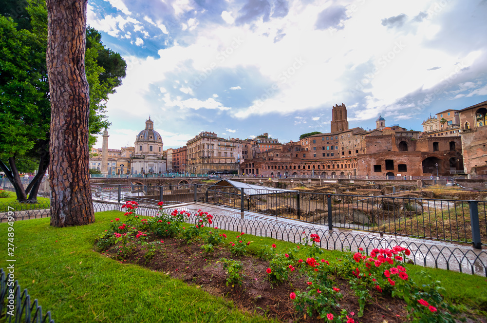 ROME, ITALY - JUNE 2014: Tourists visit Imperial Forums. The city attracts 15 million people annually