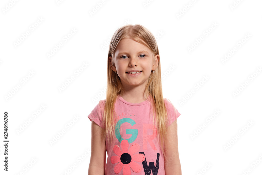 Close-up portrait of a nice blonde little kid in a pink t-shirt posing isolated on white background. Close-up portrait of a nice blonde little kid in a pink t-shirt posing isolated on white background.