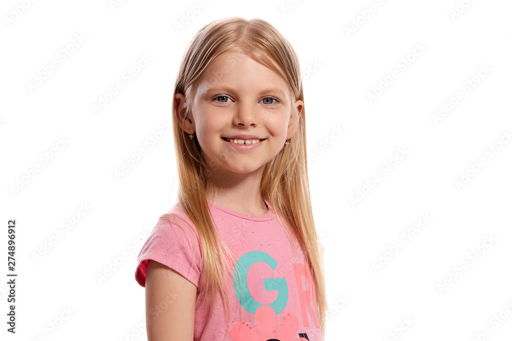 Close-up portrait of a nice blonde little kid in a pink t-shirt posing isolated on white background. Close-up portrait of a nice blonde little kid in a pink t-shirt posing isolated on white background.