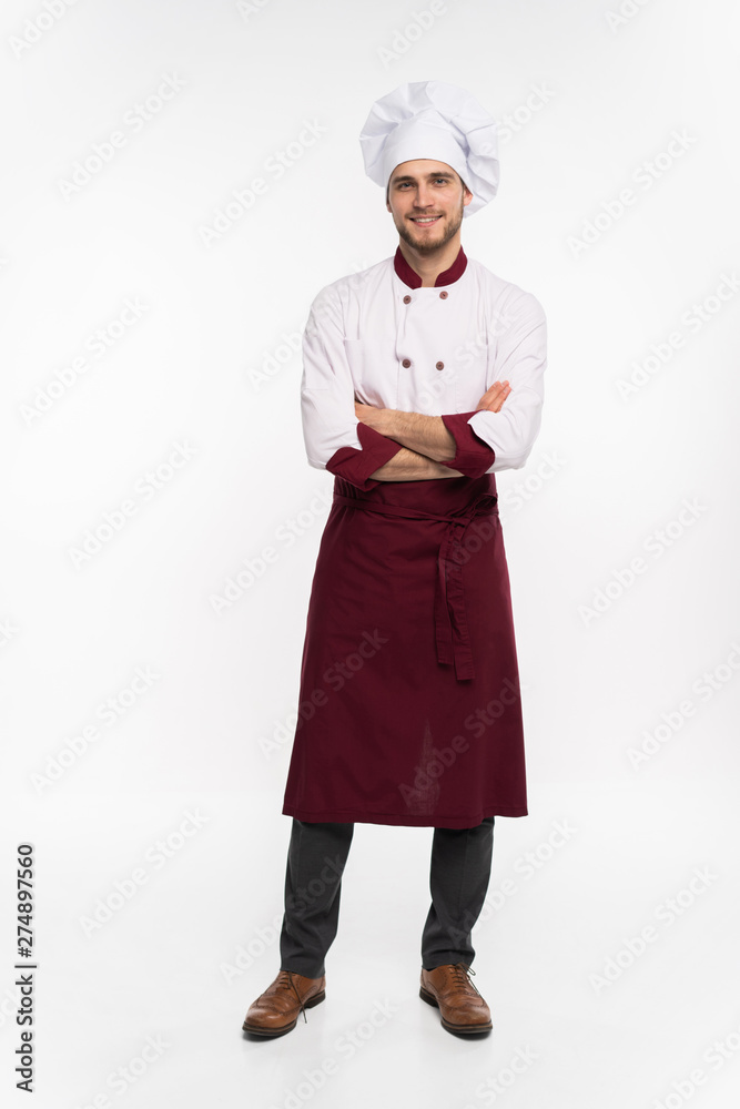 Positive handsome chef cook in beret and white outfit isolated on white background. Positive handsome chef cook in beret and white outfit isolated on white background.