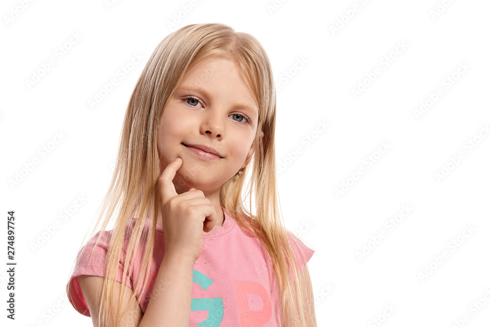Close-up portrait of a nice blonde little kid in a pink t-shirt posing isolated on white background. Close-up portrait of a nice blonde little kid in a pink t-shirt posing isolated on white background.