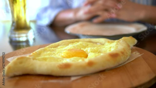 Georgian national food, Adjarian khachapuri with egg on a plate in a restaurant photo