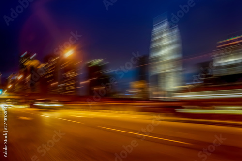 Night streets of modern building background, with speed motion effect applied © LAYHONG