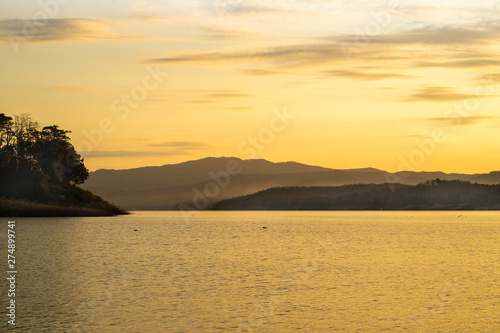 Wide-angle lake in the morning, sunrise after the mountain
