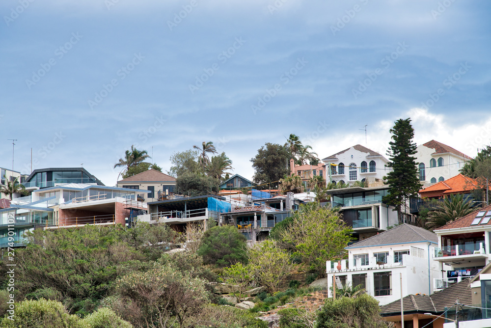 BONDI BEACH, AUSTRALIA - AUGUST 18, 2018: City homes along the coast. Bondi Beach is a famous tourist attraction