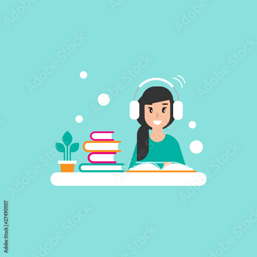 happy freelancer girl with earphones on desk with books. creative hipster work or study at home.