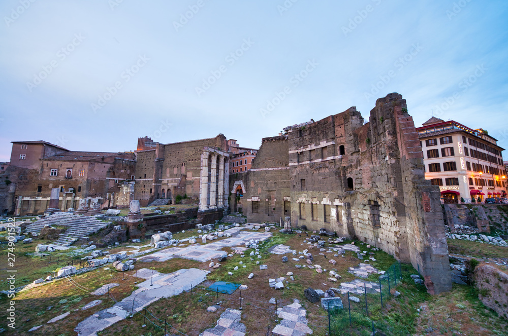 ROME, ITALY - JUNE 2014: Tourists visit Imperial Forums. The city attracts 15 million people annually