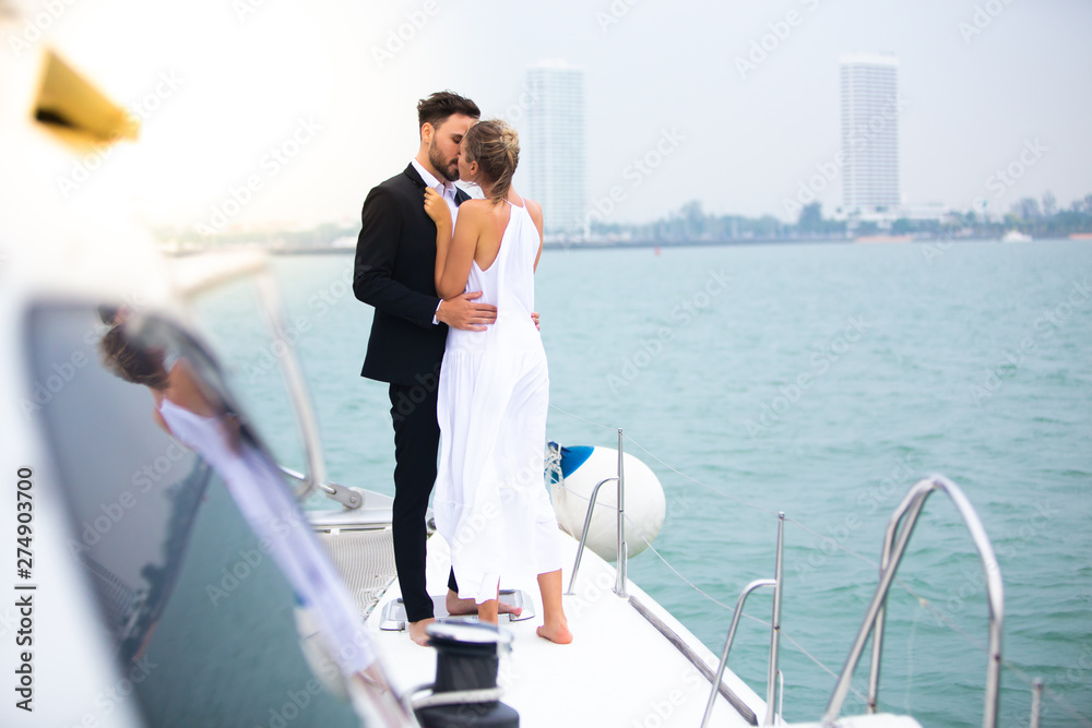 luxury business couple travelers showing their love for each other on a sailing boat. Concept business travel