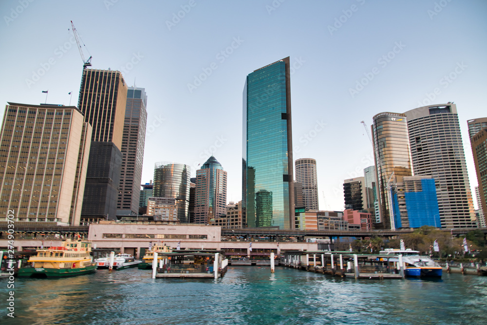 SYDNEY - AUGUST 18, 2018: City Harbor and buildings on a beautiful afternoon. Sydney attracts 20 million tourists annually