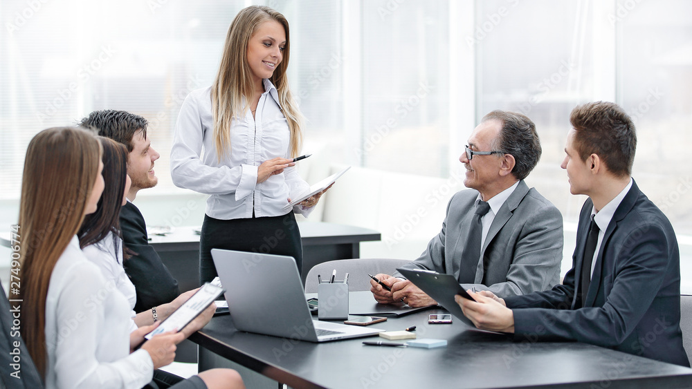 Businesswoman explaining business plan to her colleagues Businesswoman explaining business plan to her colleagues