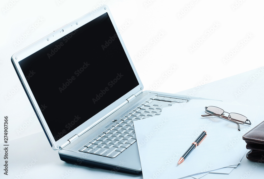 open laptop , briefcase and pen on the desktop