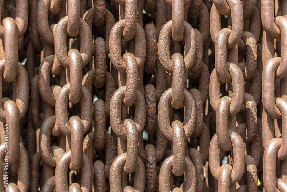 Iron chain. Chain links. Rusty background. Strong and strong connection. Heavy item. The texture of iron closeup. Grunge style. Industrial theme. Iron chain. Chain links. Rusty background. Strong and strong connection. Heavy item. The texture of iron closeup. Grunge style. Industrial theme.