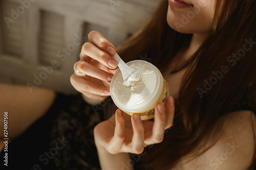 Photography Female hands holding jar of cream in home. shea butter.