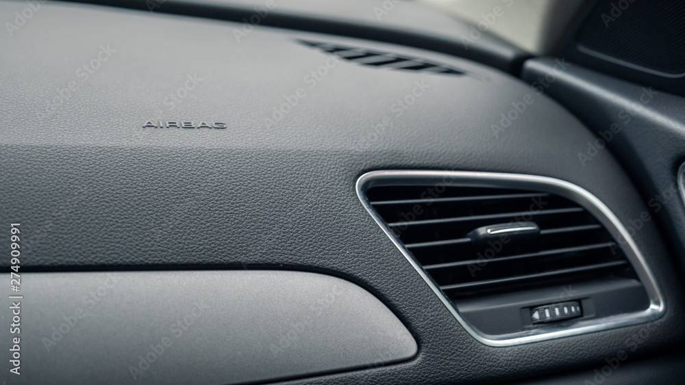 Airbag sign on the front dashboard of vehicle, close up