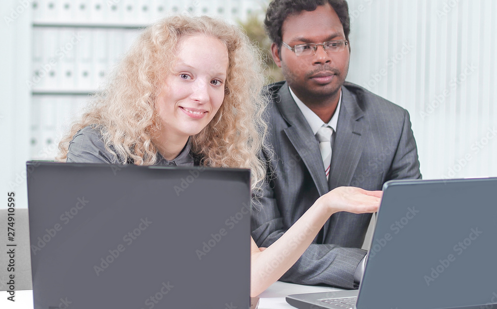 younger employees discussing business issues in office younger employees discussing business issues in office