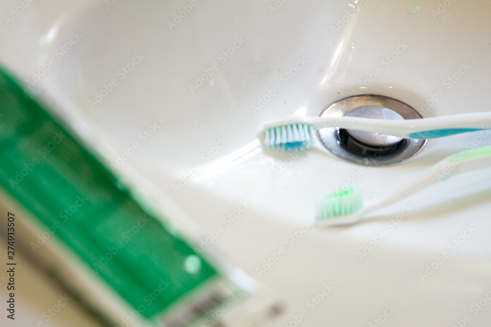 personal hygiene with toothbrush falling into the sink personal hygiene with toothbrush falling into the sink