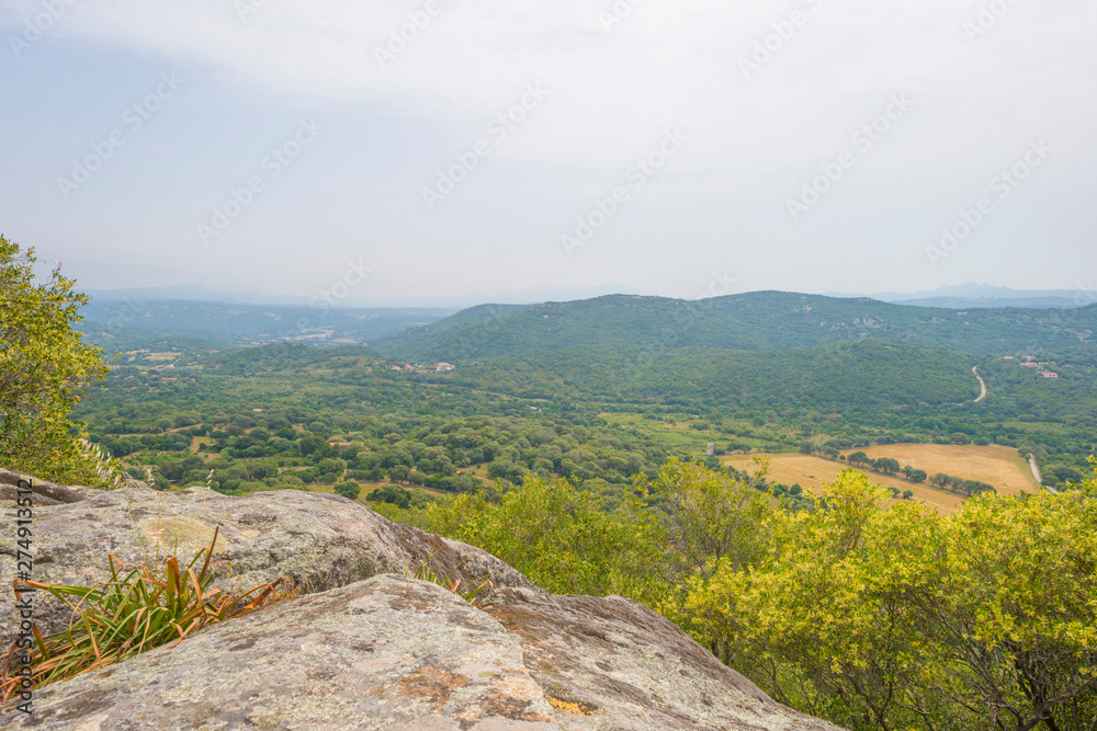 Scenic landscape of green hills and rocky mountains of the island of Sardinia in spring Scenic landscape of green hills and rocky mountains of the island of Sardinia in spring
