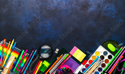 Back to school background with space for text, notebooks, pens, pencils, other stationery on blue chalk board desk, education concept, flat lay, top view