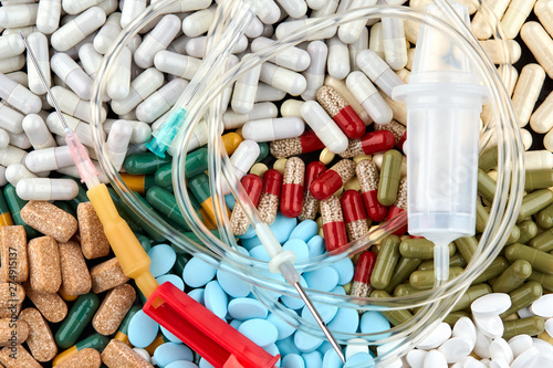 Intravenous therapy drip and many colorful pills