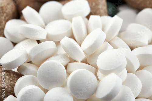 Close-up photo of small white pills. Medicine