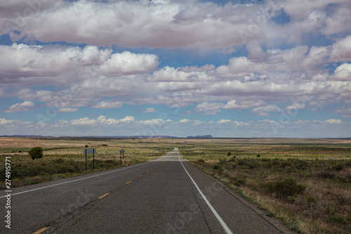 Long highway, cloudy blue sky. Monument Valley Navajo nation, Arizona-Utah USA