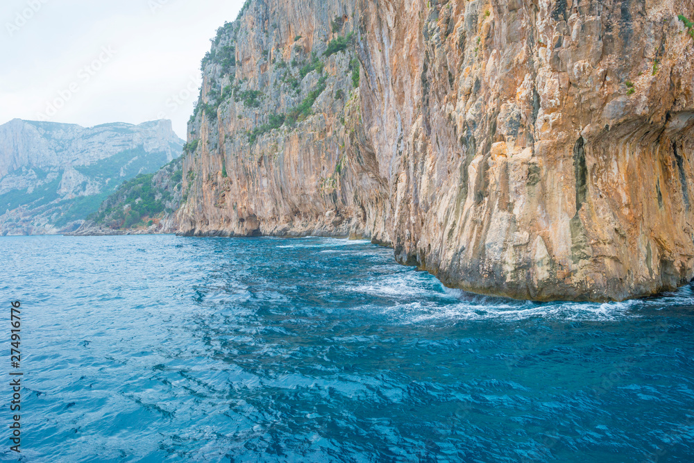 Rocky coast of the island of Sardinia in the Mediterranean Sea viewed from a boat