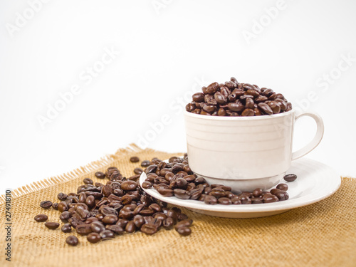 cup of coffee with beans on white background