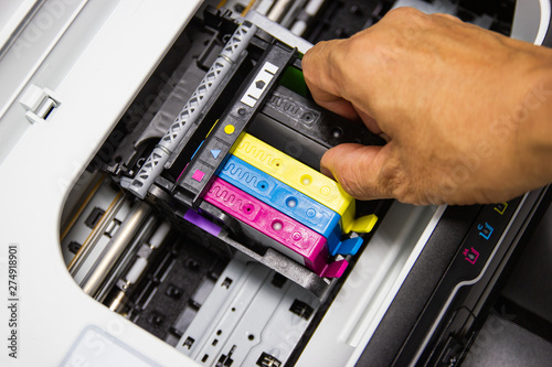 Technicians are installing the color printer inkjet cartridge