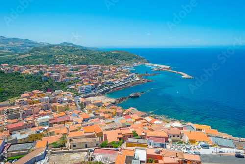 View of the town of Castelsardo on a hill and along the sea in sunlight in spring