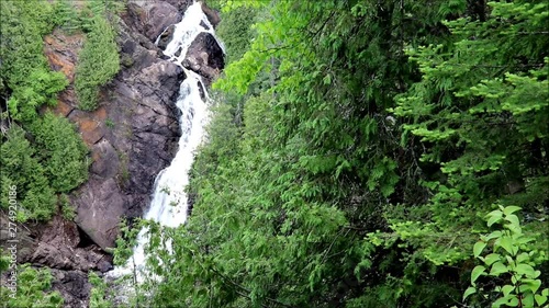 Waterfall seen through the forest trees