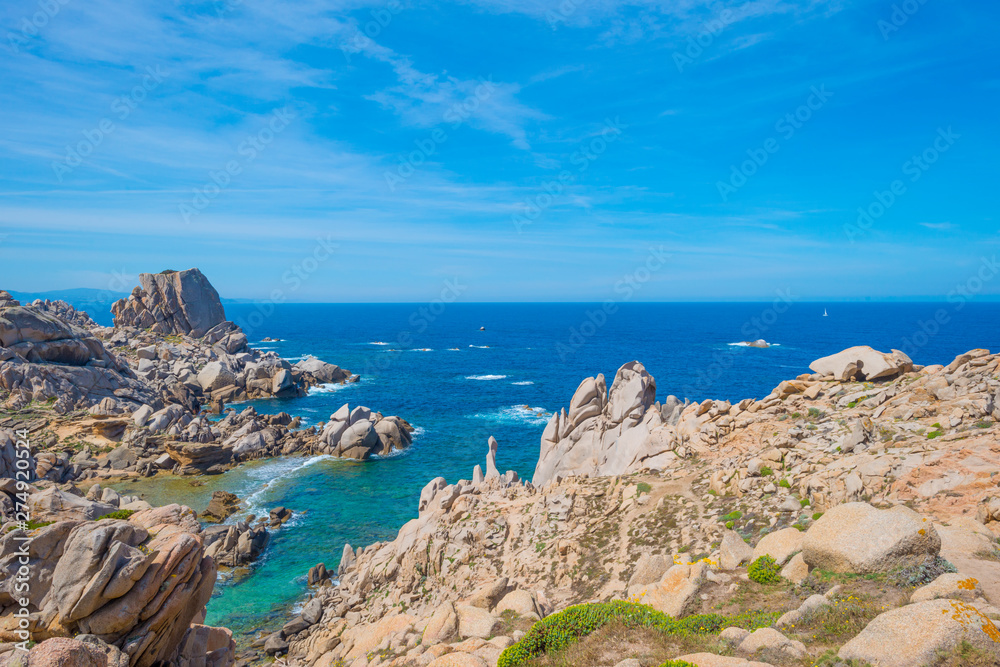 Rocky coast of the island of Sardinia in the Mediterranean Sea in sunlight in spring