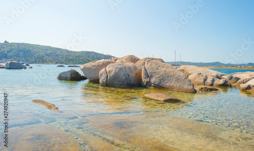 Rocky coast of the island of Sardinia in the Mediterranean Sea in sunlight in spring © Naj