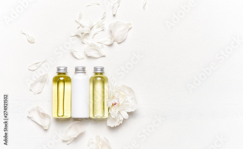 Spa concept with massage oils decorated with floral petals