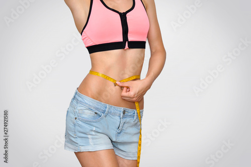 Beautiful sports belly WITH MEASURING AROUND WOMEN'S WAIST WHICH SHOWS 63 CENTIMETERS.