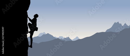 Fotografiet Black silhouette of a climber on a cliff with mountains as a background