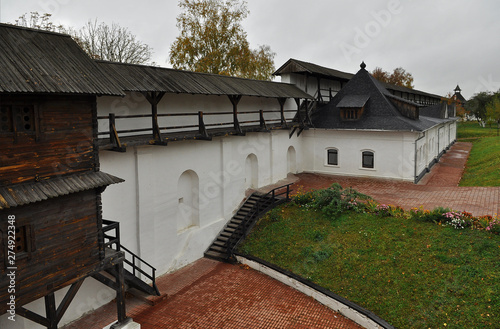 An old wooden fortress with high walls and a water ditch photo