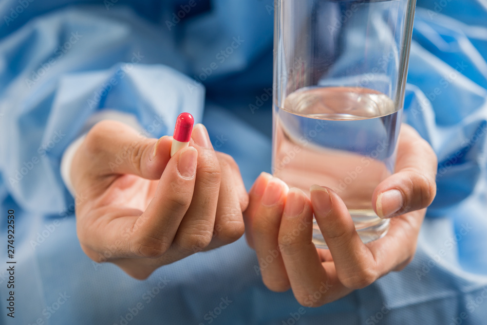 Woman's hand pours the medicine pills out of the bottle Woman's hand pours the medicine pills out of the bottle