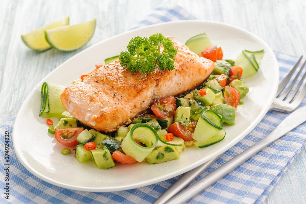 Grilled salmon fillet with vegetable salad. Grilled salmon fillet with vegetable salad.