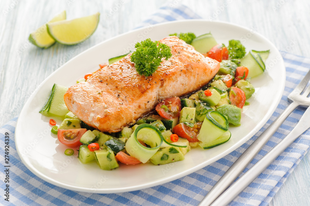 Grilled salmon fillet with vegetable salad.