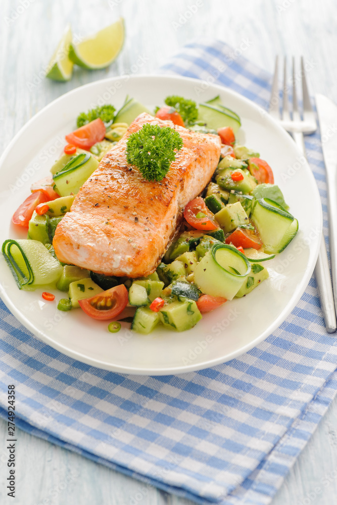 Grilled salmon fillet with vegetable salad. Grilled salmon fillet with vegetable salad.