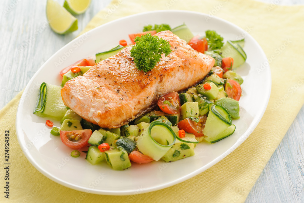 Grilled salmon fillet with vegetable salad.