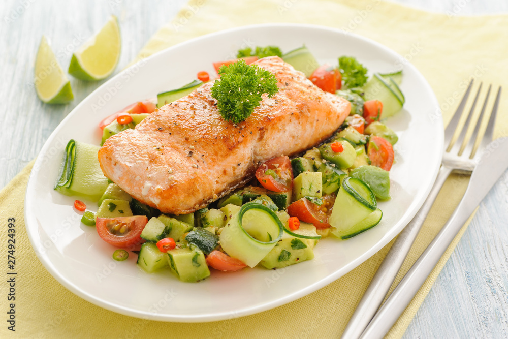 Grilled salmon fillet with vegetable salad.