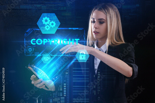 The concept of business, technology, the Internet and the network. A young entrepreneur working on a virtual screen of the future and sees the inscription: Copyright