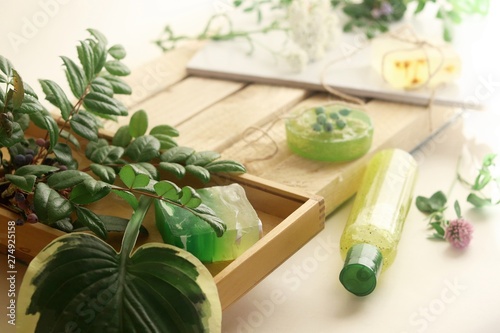 Natural soap, plants and berries on a wooden table, spa procedures, body care, healthy lifestyle