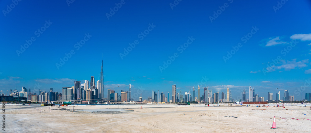 Wide panorama of Dubai cityscapes with Burj Khalifa at daytime