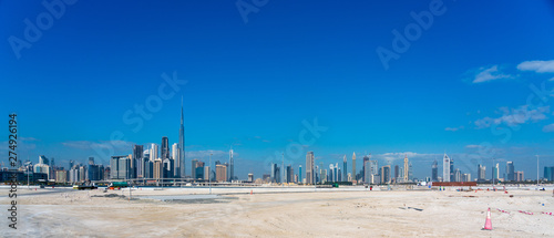 Wide panorama of Dubai cityscapes with Burj Khalifa at daytime