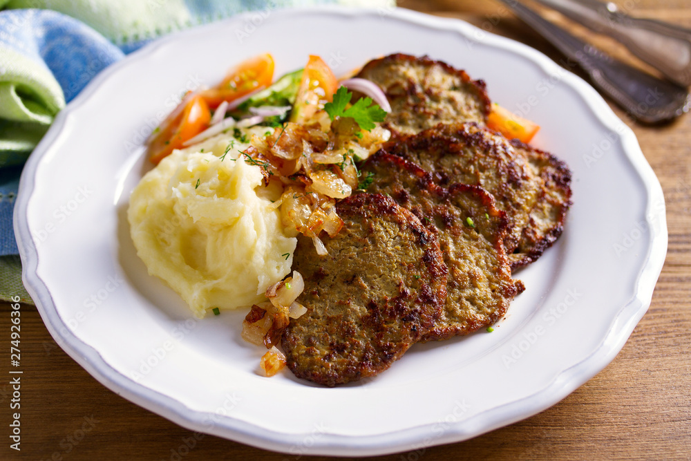Beef liver pancakes with mashed potato and vegetables. Liver side dish Beef liver pancakes with mashed potato and vegetables. Liver side dish
